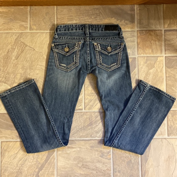 Low cut, boot cut jeans.  Small wear in pocket.  Shown in pictures - Picture 4 of 9